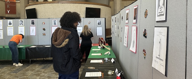 Student looking at poster during campus event